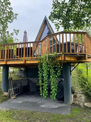 a house with a deck on top of it at NEW! Glamping House with new hot tub and sauna- Hisa oddiha UPDATED DECEMBER 2025 in Smarjeske Toplice