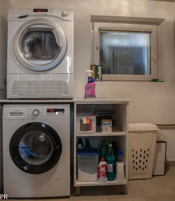 a washing machine and a dryer in a room at Apartment Activity in Radomlje