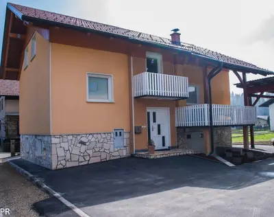 a small house with a white door and balcony at Apartment Activity in Radomlje