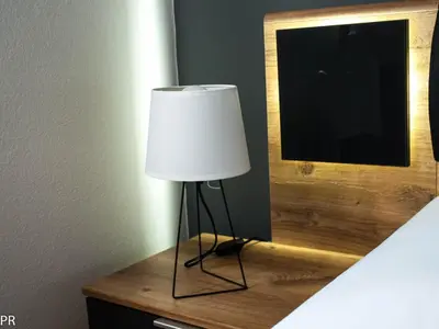 a lamp sitting on a table next to a mirror at Apartment Activity in Radomlje