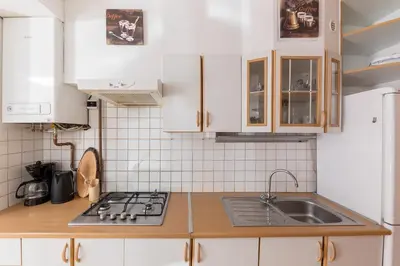 a kitchen with white cabinets and a sink at Apartma Valsar Rogla in Zreče