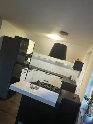 an overhead view of a kitchen with black and white at Apartment with mountain view and rivers close by in Šmartno ob Dreti