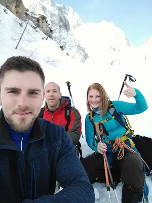 a group of three people on a snow covered mountain at Apartment with mountain view and rivers close by in Šmartno ob Dreti