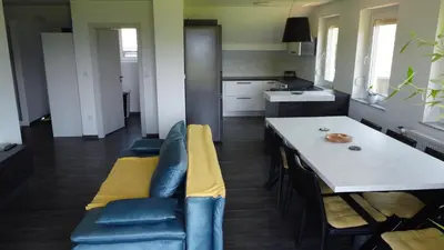 a kitchen with a couch and a table in a room at Apartment with mountain view and rivers close by in Šmartno ob Dreti