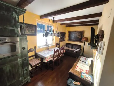 a living room with a table and a couch at Apartma Antico in Kranjska Gora