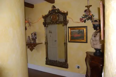 an ornate mirror on a wall in a room at Apartma Antico in Kranjska Gora