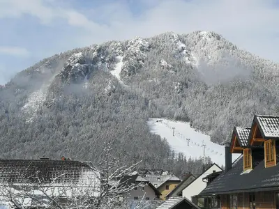a mountain covered in snow with a ski slope at Apartma Antico in Kranjska Gora