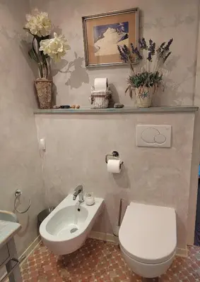 a bathroom with a white toilet and a sink at Apartma Antico in Kranjska Gora