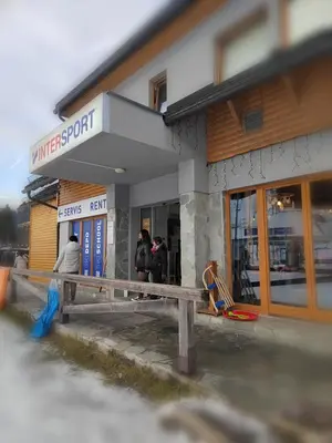 a group of people standing outside of a store at Apartma Antico in Kranjska Gora