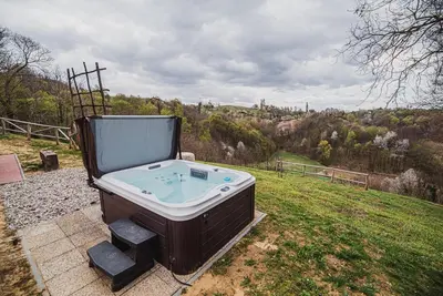 a bath tub sitting on top of a field at Holiday Home Liberg with Hot tub and Sauna in Brežice