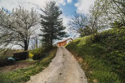 a dirt road leading to a house on a hill at Holiday Home Liberg with Hot tub and Sauna in Brežice