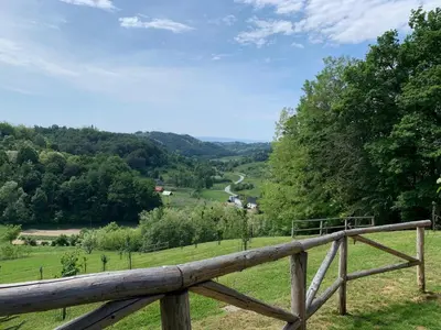 a wooden fence with a view of a valley at Holiday Home Liberg with Hot tub and Sauna in Brežice