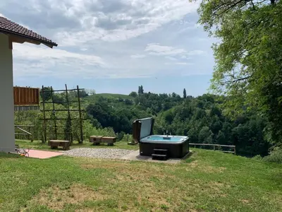 a hot tub sitting on the side of a yard at Holiday Home Liberg with Hot tub and Sauna in Brežice