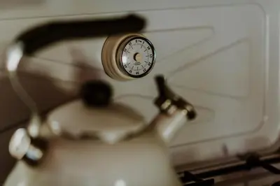 a clock sitting on top of a tea kettle at Marko's eco cabin in Bled