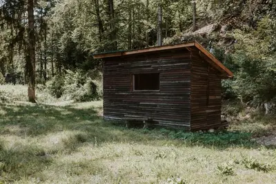 a small wooden building in the middle of a field at Marko's eco cabin in Bled