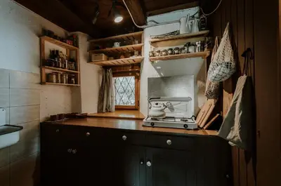 a small kitchen with a stove and a window at Marko's eco cabin in Bled