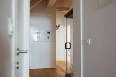 a hallway with a door and a mirror at Sunny Retreat Apartment in Kranjska Gora