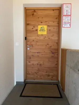 a wooden door with a sign on it at Sunny Retreat Apartment in Kranjska Gora