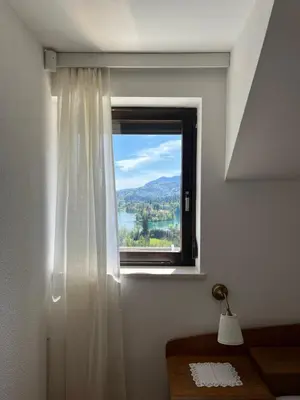 a window with a view of a mountain at Lakeview Guesthouse & Chalet Bled in Bled