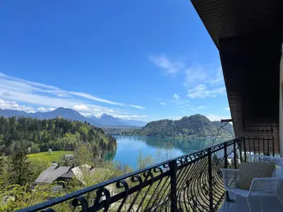 a view of a lake from the balcony of a house at Lakeview Guesthouse & Chalet Bled in Bled