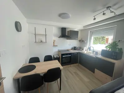 a kitchen with a table and chairs in a room at Apartma Toni Bovec in Bovec
