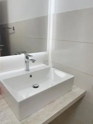 a bathroom with a white sink and a mirror at Apartma Toni Bovec in Bovec