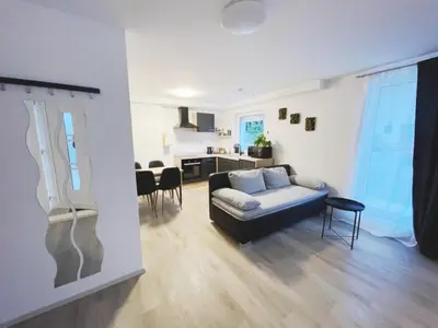 a living room with a couch and a kitchen at Apartma Toni Bovec in Bovec