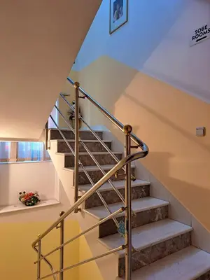 a staircase in a house with a metal railing at Rooms Čehovin in Postojna