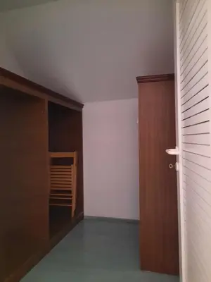 an empty room with a closet and a door at Rooms Čehovin in Postojna