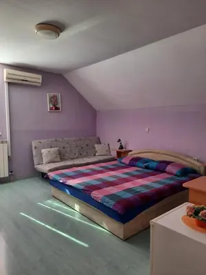 a bedroom with a bed with lights on the floor at Rooms Čehovin in Postojna