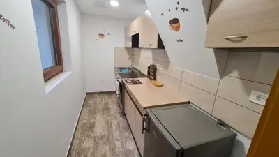 a small kitchen with a counter and a sink at Radovna Mountain Valley Cottage in Zgornje Gorje