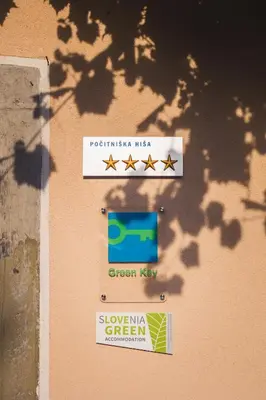 a sign on the side of a building with four stars at BELAKAPA Authentic house with garden and free parking in Ilirska Bistrica