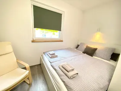 a small bedroom with a bed and a window at Apartment 3 Sovice in Bovec