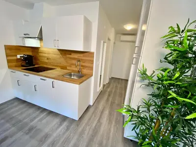 a kitchen with white cabinets and a sink at Apartment 3 Sovice in Bovec