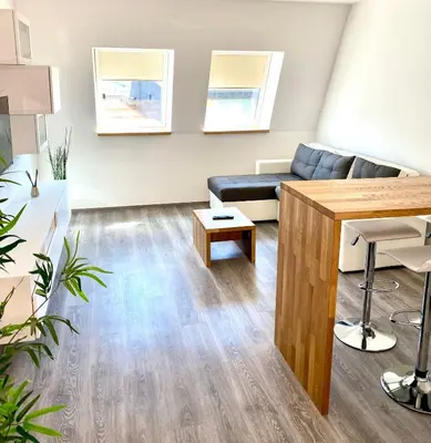 a living room with a couch and a table at Apartment 3 Sovice in Bovec