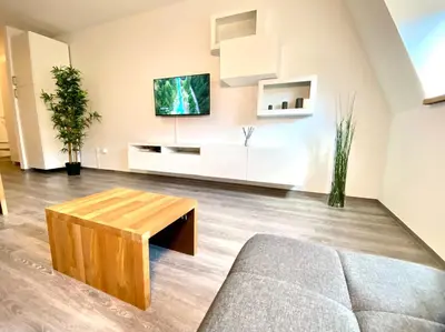 a living room with a couch and a table at Apartment 3 Sovice in Bovec