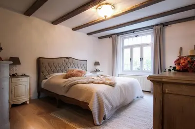a bedroom with a bed with a stuffed animal on it at Vila Vilma Vineyard Cottage in Lendava