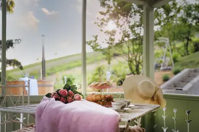 a table with a hat and some food on it at Vila Vilma Vineyard Cottage in Lendava