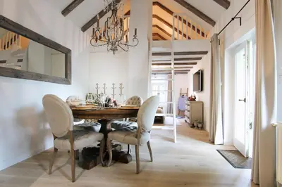 a dining room with a table and chairs and a chandelier at Vila Vilma Vineyard Cottage in Lendava