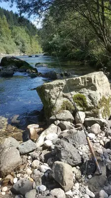 a rod and rope on a river with rocks at Guesthouse S in Luče