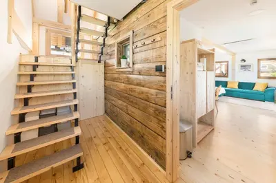 a tiny house with a wooden wall at Captain's Lodge in Bohinj