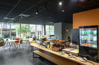 a restaurant with a counter with food on it at B&B Hotel Maribor in Maribor