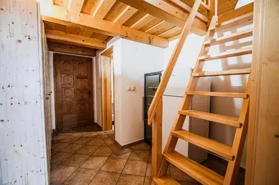a room with a wooden staircase in a house at Vineyard Cottage Maleric with Pool Access in Dragatuš