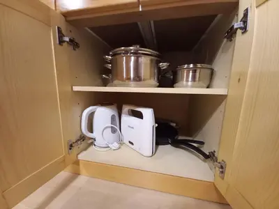 a cabinet with two pots and a appliance in it at Vineyard Cottage Maleric with Pool Access in Dragatuš