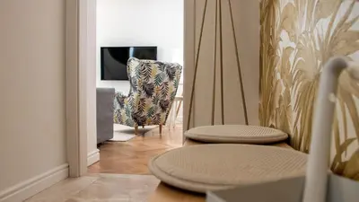 a living room with a chair and a table at Sunnyside Apartment in the City Center in Ljubljana