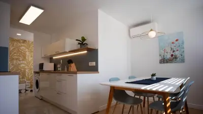 a kitchen with a table and chairs in a room at Sunnyside Apartment in the City Center in Ljubljana