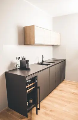 a kitchen with a black counter and a sink at Villa Vajta in Dobrovo