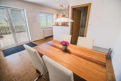a dining room with a wooden table and chairs at Apartment pri Povhih in Slovenske Konjice