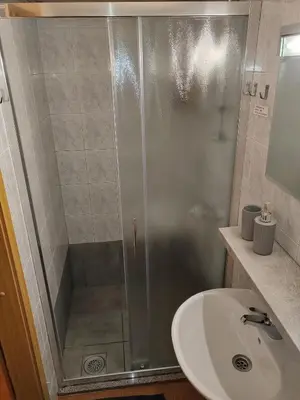 a bathroom with a shower and a sink at Cottage Barbara with Sauna in Škofja Loka