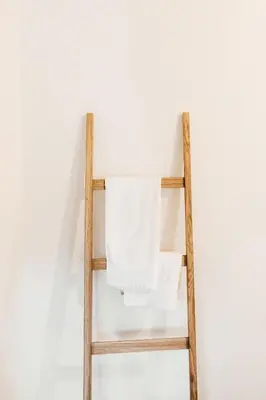 a wooden towel rack with a white towel at Grad Štanjel House in Štanjel